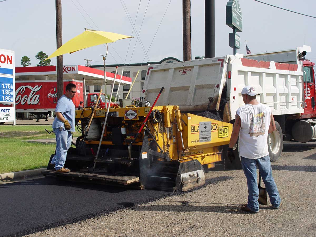 Pro-Pave crew operating machines to melt, spread and smooth new asphalt surface